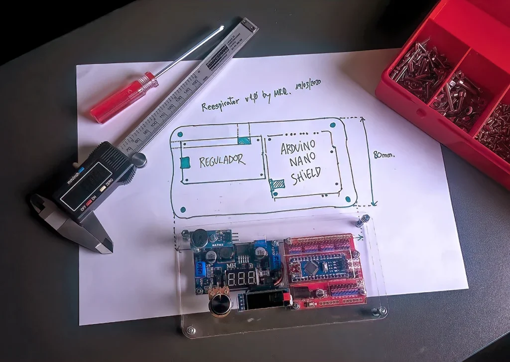 Prototype ventilator electronics and enclosure design shown alongside hand-drawn engineering sketches, measuring tools and components.